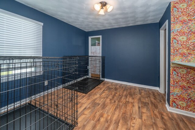 unfurnished room with wood finished floors and baseboards