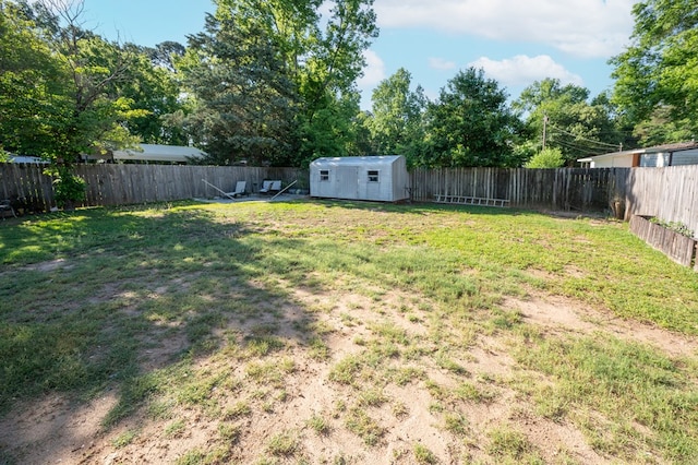 view of yard featuring a storage shed and an outbuilding
