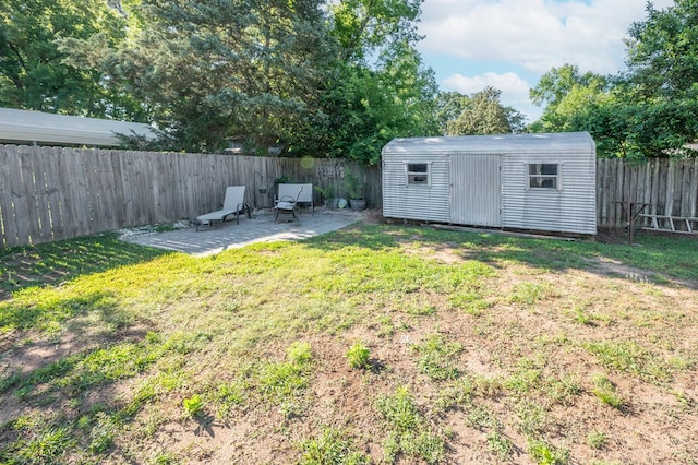 view of yard with a patio area, an outdoor structure, and a shed