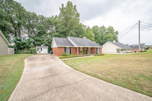 ranch-style house with a front lawn and a shed