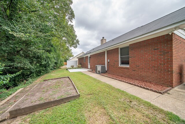 view of yard featuring central AC unit and a patio