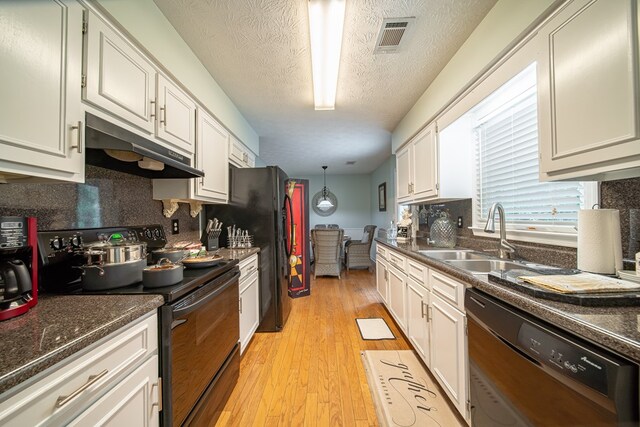 kitchen with sink, white cabinets, light wood-type flooring, and black appliances