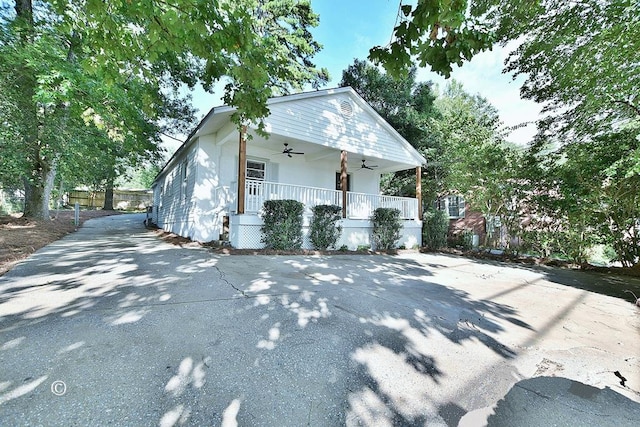 view of property exterior featuring ceiling fan and a porch