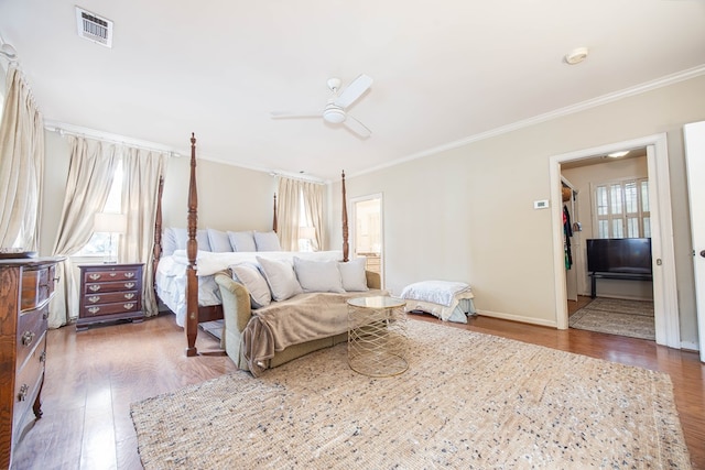 bedroom featuring ceiling fan, dark hardwood / wood-style flooring, and crown molding