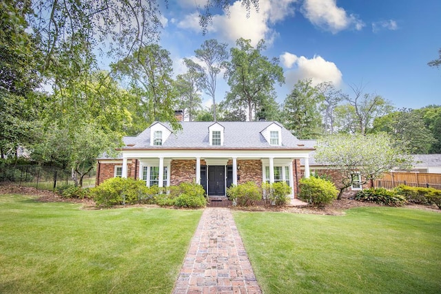 cape cod-style house featuring a front yard