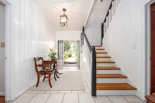 stairs with tile patterned flooring and a barn door