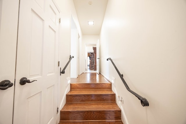 staircase with hardwood / wood-style floors