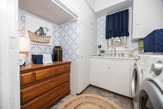 washroom featuring washer and dryer, sink, and cabinets