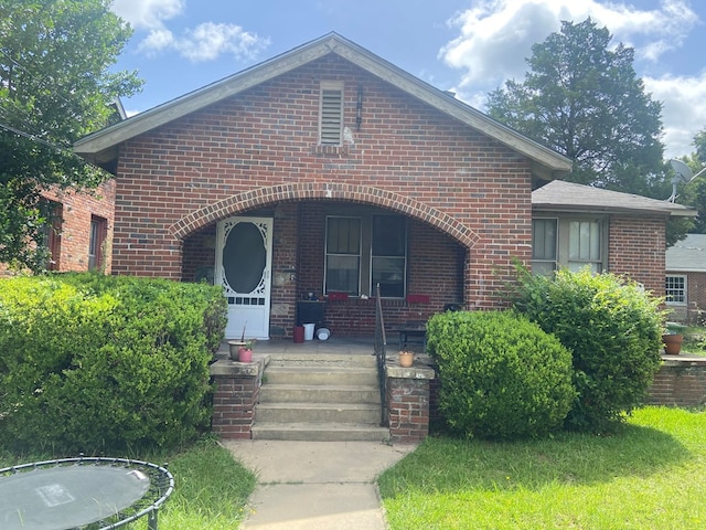 view of front of property with a porch and brick siding