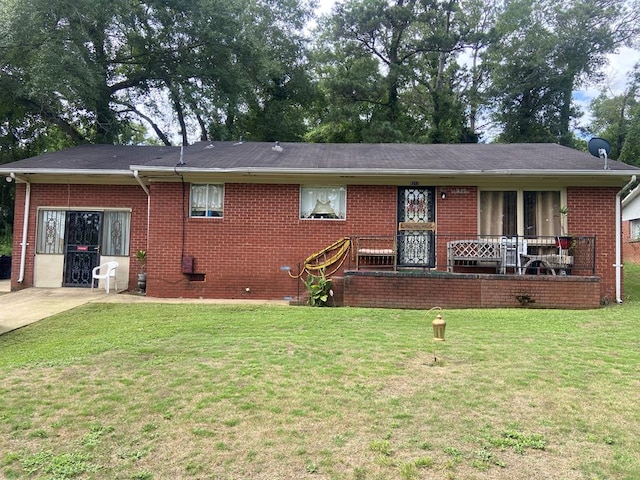 view of front facade with a front yard and brick siding