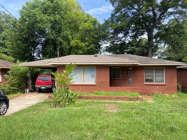 view of home's exterior featuring driveway, a yard, an attached carport, and brick siding