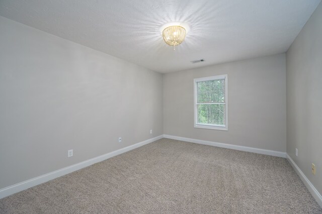 2708 Sawgrass Ln, Phenix City, AL 36867 - unfurnished room featuring an inviting chandelier, baseboards, carpet, and visible vents