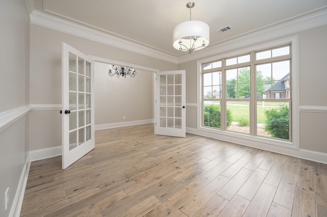2708 Sawgrass Ln, Phenix City, AL 36867 - unfurnished dining area with french doors, crown molding, a notable chandelier, and light wood-type flooring