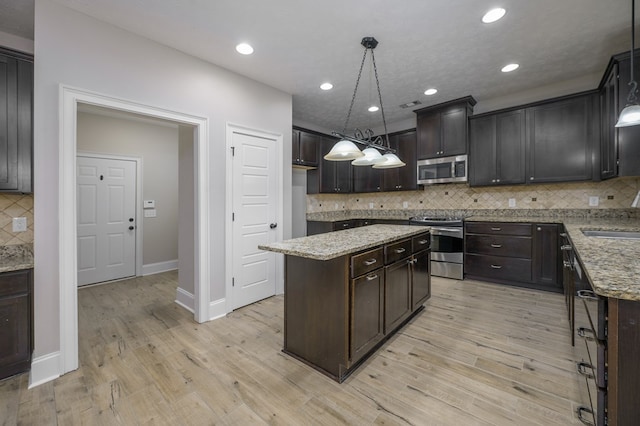 2708 Sawgrass Ln, Phenix City, AL 36867 - kitchen featuring backsplash, stainless steel appliances, light stone countertops, and dark brown cabinets
