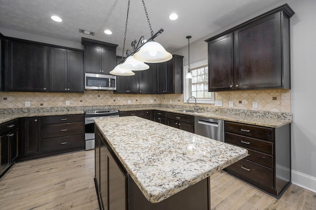2708 Sawgrass Ln, Phenix City, AL 36867 - kitchen featuring baseboards, appliances with stainless steel finishes, a sink, and light wood-style flooring