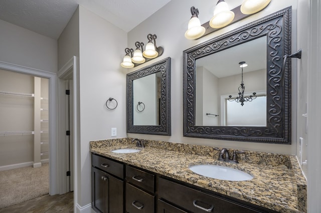 2708 Sawgrass Ln, Phenix City, AL 36867 - full bath featuring double vanity, a sink, baseboards, and a walk in closet