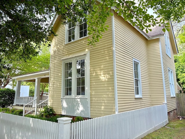 view of side of home with fence