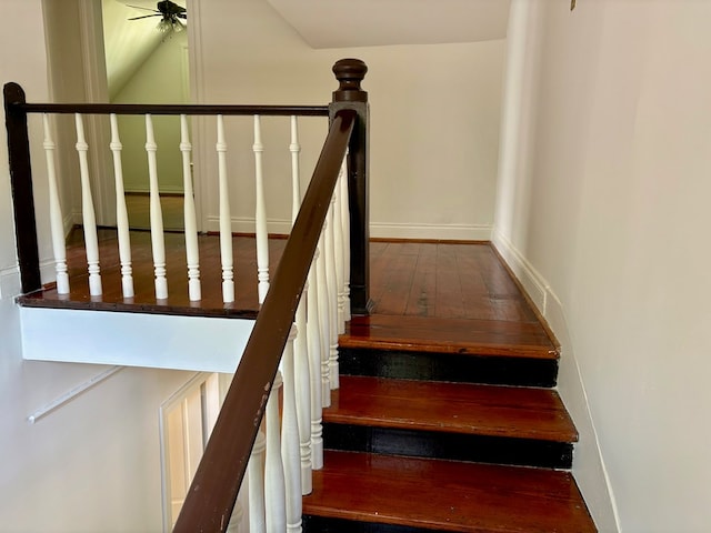 stairs with wood-type flooring, baseboards, and ceiling fan