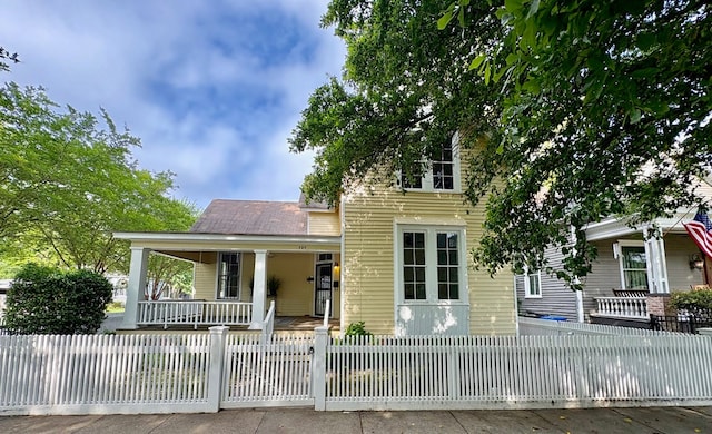 view of front of house with a porch and a fenced front yard