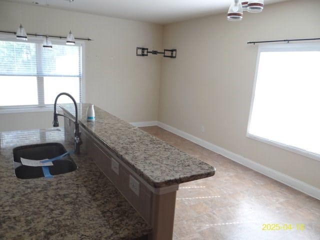 8 Rusty Dr, Phenix City, AL 36869 - kitchen featuring a wealth of natural light, baseboards, and a sink