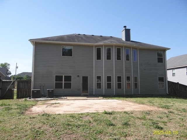 8 Rusty Dr, Phenix City, AL 36869 - rear view of property featuring fence, a chimney, a lawn, and a patio area