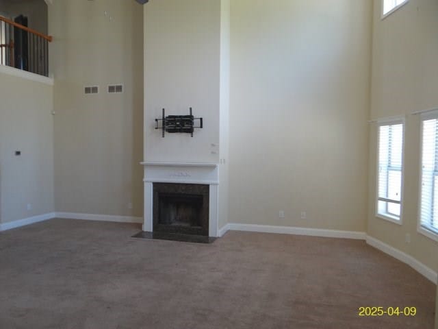 8 Rusty Dr, Phenix City, AL 36869 - unfurnished living room featuring a high ceiling, visible vents, and a wealth of natural light