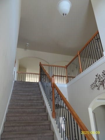 8 Rusty Dr, Phenix City, AL 36869 - stairway with arched walkways and a towering ceiling