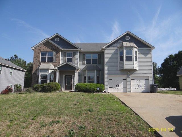 8 Rusty Dr, Phenix City, AL 36869 - view of front of house featuring a front yard, driveway, and a garage