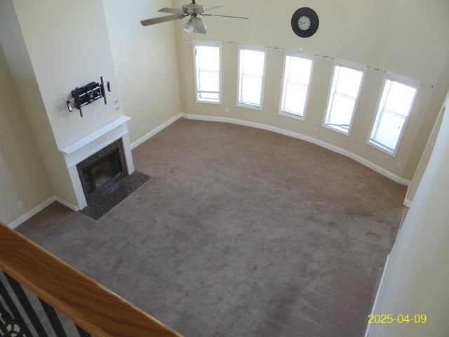 8 Rusty Dr, Phenix City, AL 36869 - unfurnished living room featuring a ceiling fan, carpet floors, and baseboards