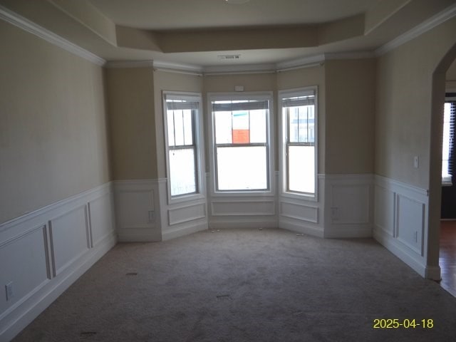 8 Rusty Dr, Phenix City, AL 36869 - carpeted spare room featuring a raised ceiling, a wainscoted wall, arched walkways, and a decorative wall