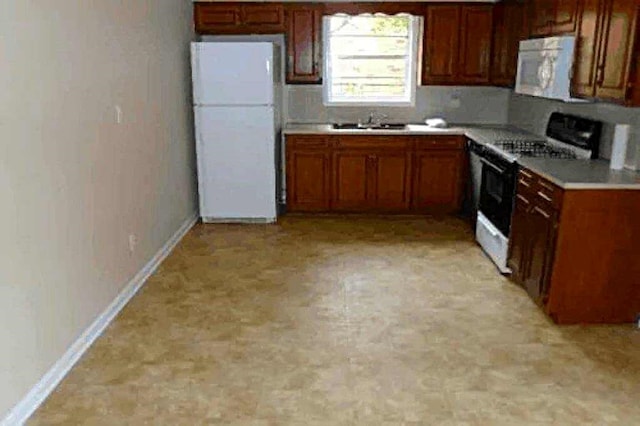 kitchen with white appliances and sink