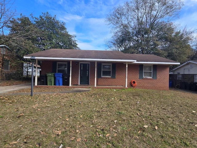 ranch-style house featuring a carport and a front lawn