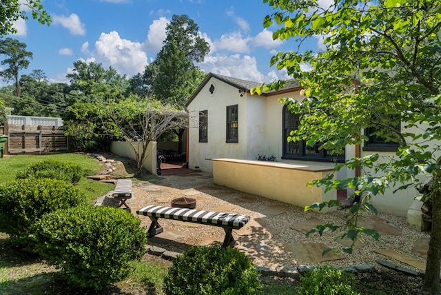 1580 Dixon Dr, Columbus, GA 31906 - rear view of house with an outdoor fire pit and stucco siding