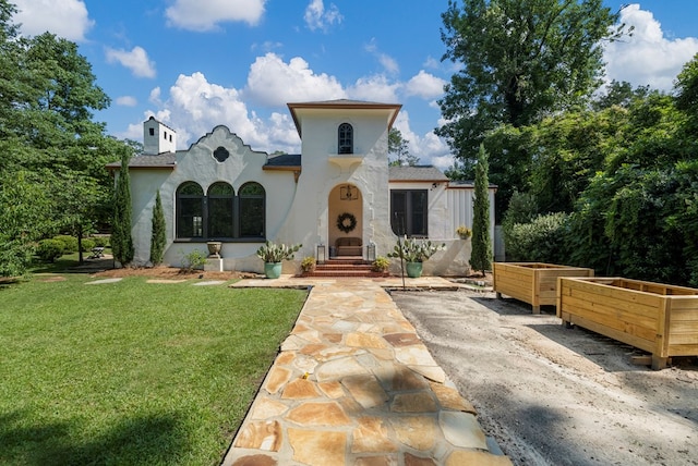 1580 Dixon Dr, Columbus, GA 31906 - mediterranean / spanish house featuring a front yard, stucco siding, and a chimney