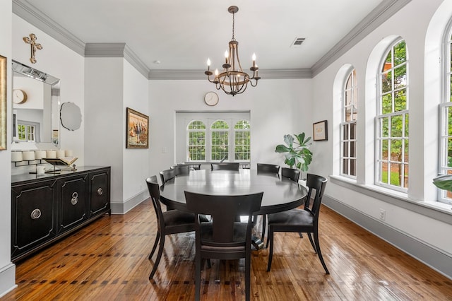 1580 Dixon Dr, Columbus, GA 31906 - dining space featuring a chandelier, wood-type flooring, and crown molding