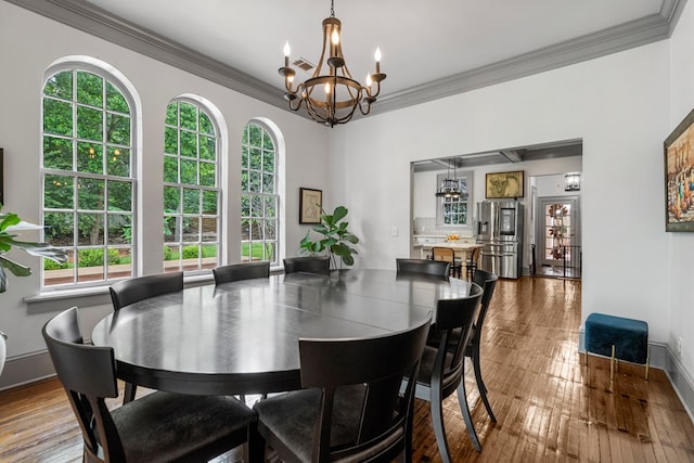 1580 Dixon Dr, Columbus, GA 31906 - dining space featuring crown molding, a chandelier, healthy amount of natural light, and hardwood / wood-style floors