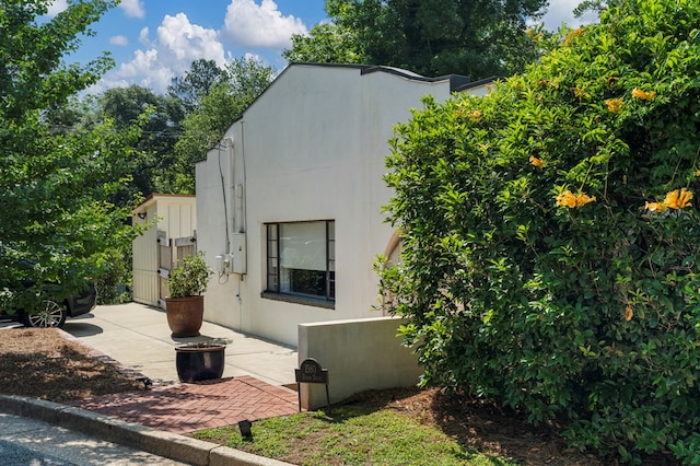 1580 Dixon Dr, Columbus, GA 31906 - view of side of home with stucco siding and a patio area