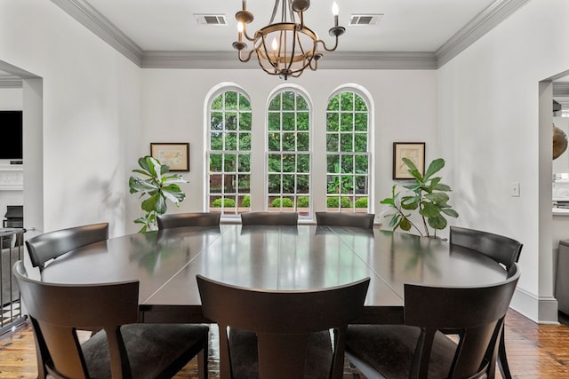 1580 Dixon Dr, Columbus, GA 31906 - dining room with a chandelier, crown molding, wood finished floors, and a fireplace