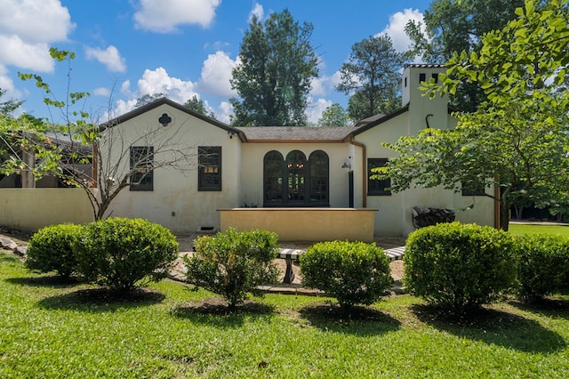 1580 Dixon Dr, Columbus, GA 31906 - mediterranean / spanish-style home with a front lawn and stucco siding
