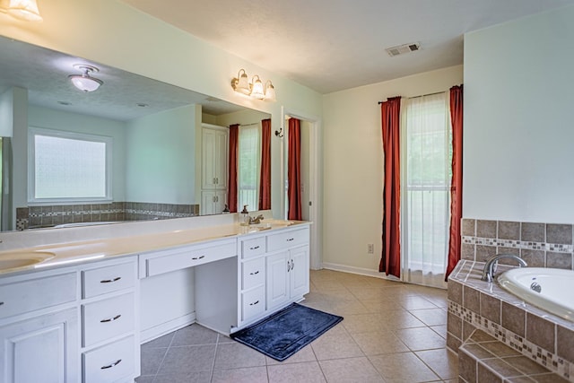 full bathroom with tile patterned flooring, double vanity, a garden tub, and baseboards