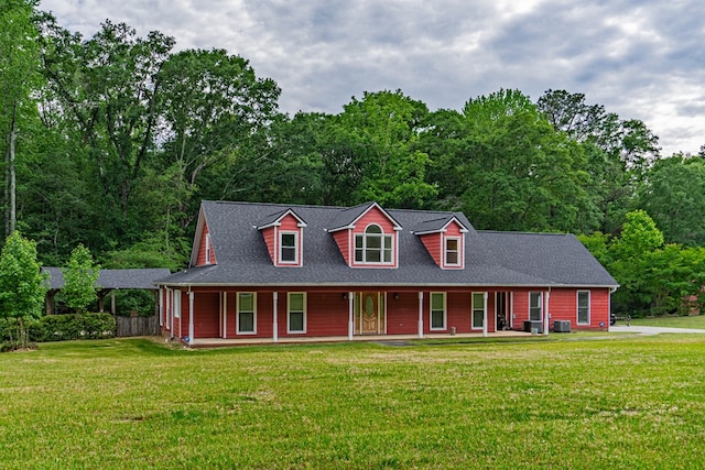 view of front of home with a porch, a front yard, and roof with shingles