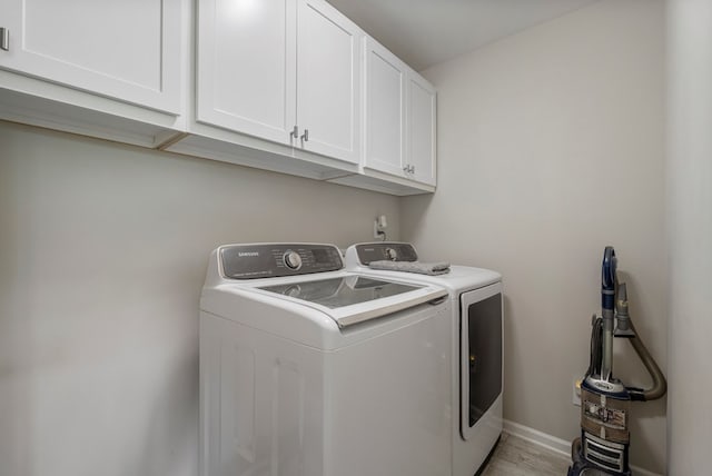 221 Abberly Ln, Ellerslie, GA 31807 - laundry area featuring cabinet space, independent washer and dryer, and light wood finished floors