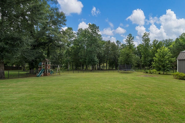 221 Abberly Ln, Ellerslie, GA 31807 - fenced backyard with a trampoline and a playground