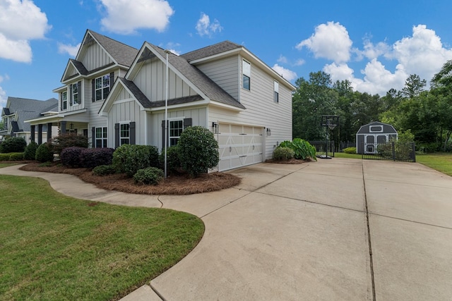 221 Abberly Ln, Ellerslie, GA 31807 - view of property exterior featuring board and batten siding, concrete driveway, an attached garage, a shingled roof, and a shed