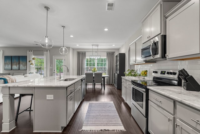 221 Abberly Ln, Ellerslie, GA 31807 - kitchen with stainless steel appliances, open floor plan, a kitchen bar, recessed lighting, and decorative backsplash