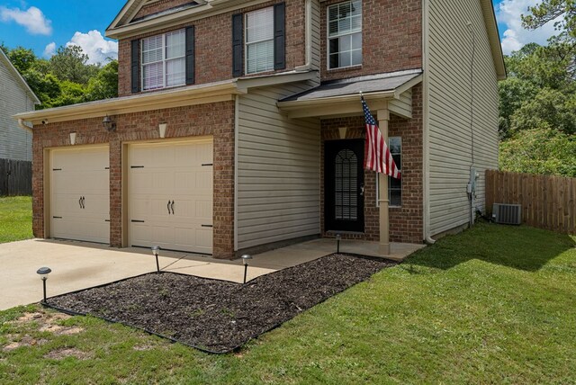 917 Dawkins Ct, Phenix City, AL 36867 - view of front of house with an attached garage, concrete driveway, brick siding, and central AC