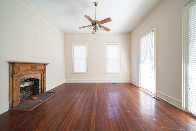 unfurnished living room with ceiling fan, a healthy amount of sunlight, and dark hardwood / wood-style flooring