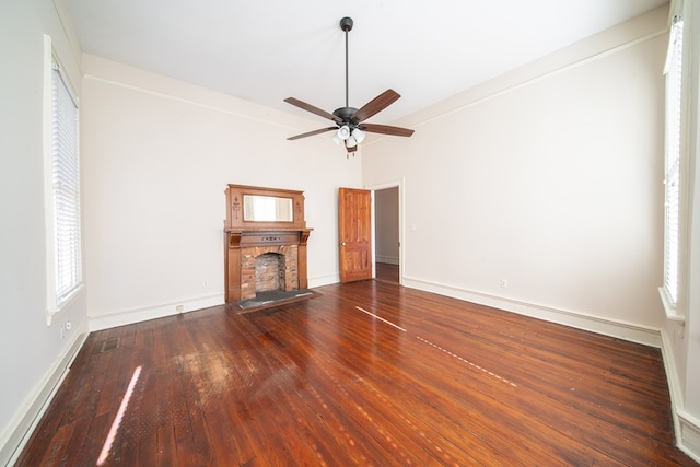 unfurnished living room with dark wood-type flooring, ornamental molding, and ceiling fan