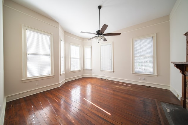 unfurnished living room featuring dark hardwood / wood-style floors and ceiling fan