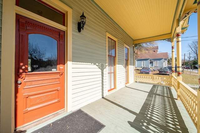 view of exterior entry with a porch